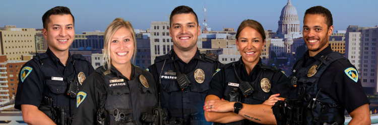 Five uniformed police officers smiling.